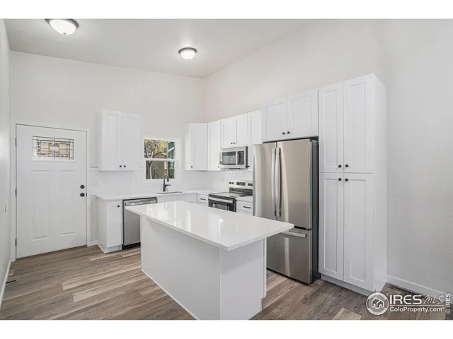 a kitchen with stainless steel appliances a refrigerator sink and cabinets