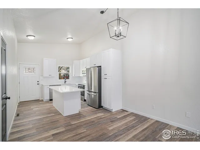 a view of kitchen with refrigerator microwave and stove