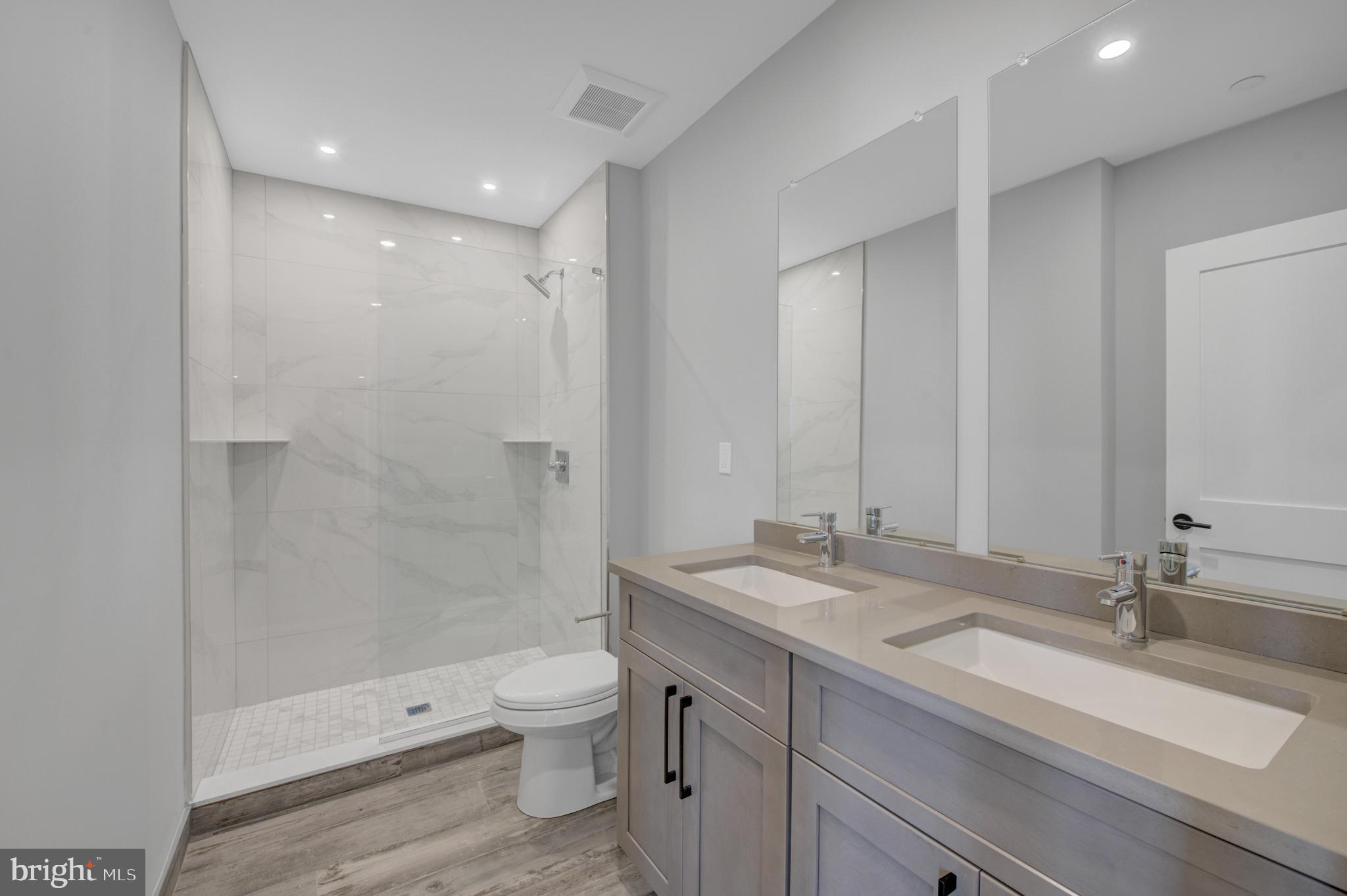 2445 Innovator Way, Unit 3D Philadelphia, PA 19146 - Photo 11 of 19 a bathroom with a double vanity sink toilet and shower