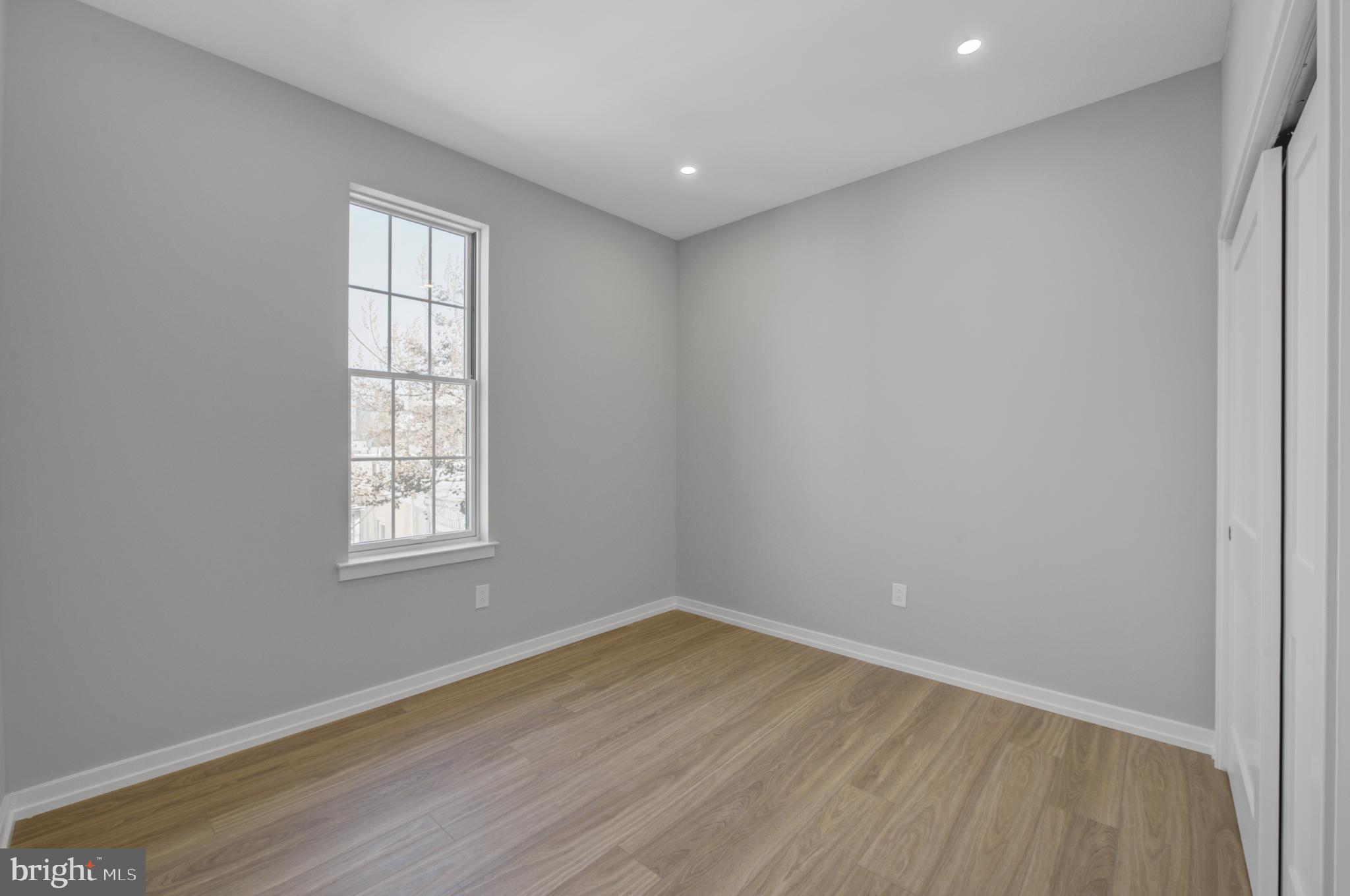 2445 Innovator Way, Unit 3D Philadelphia, PA 19146 - Photo 12 of 19 an empty room with wooden floor and windows