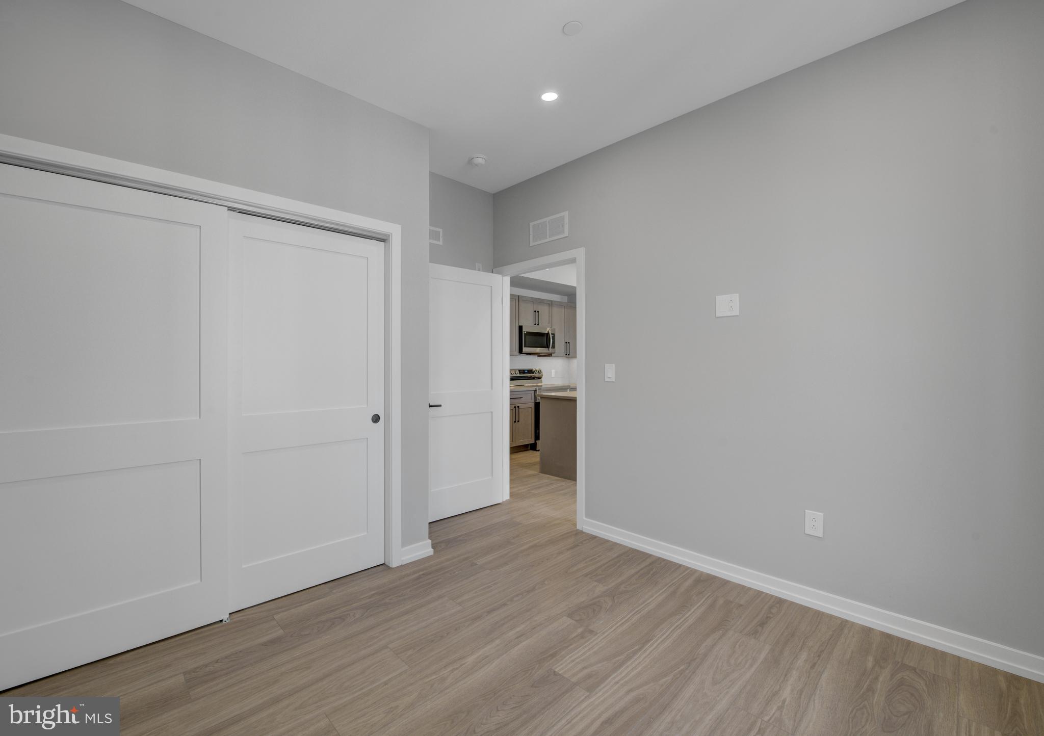 2445 Innovator Way, Unit 3D Philadelphia, PA 19146 - Photo 13 of 19 a view of an empty room with wooden floor and closet