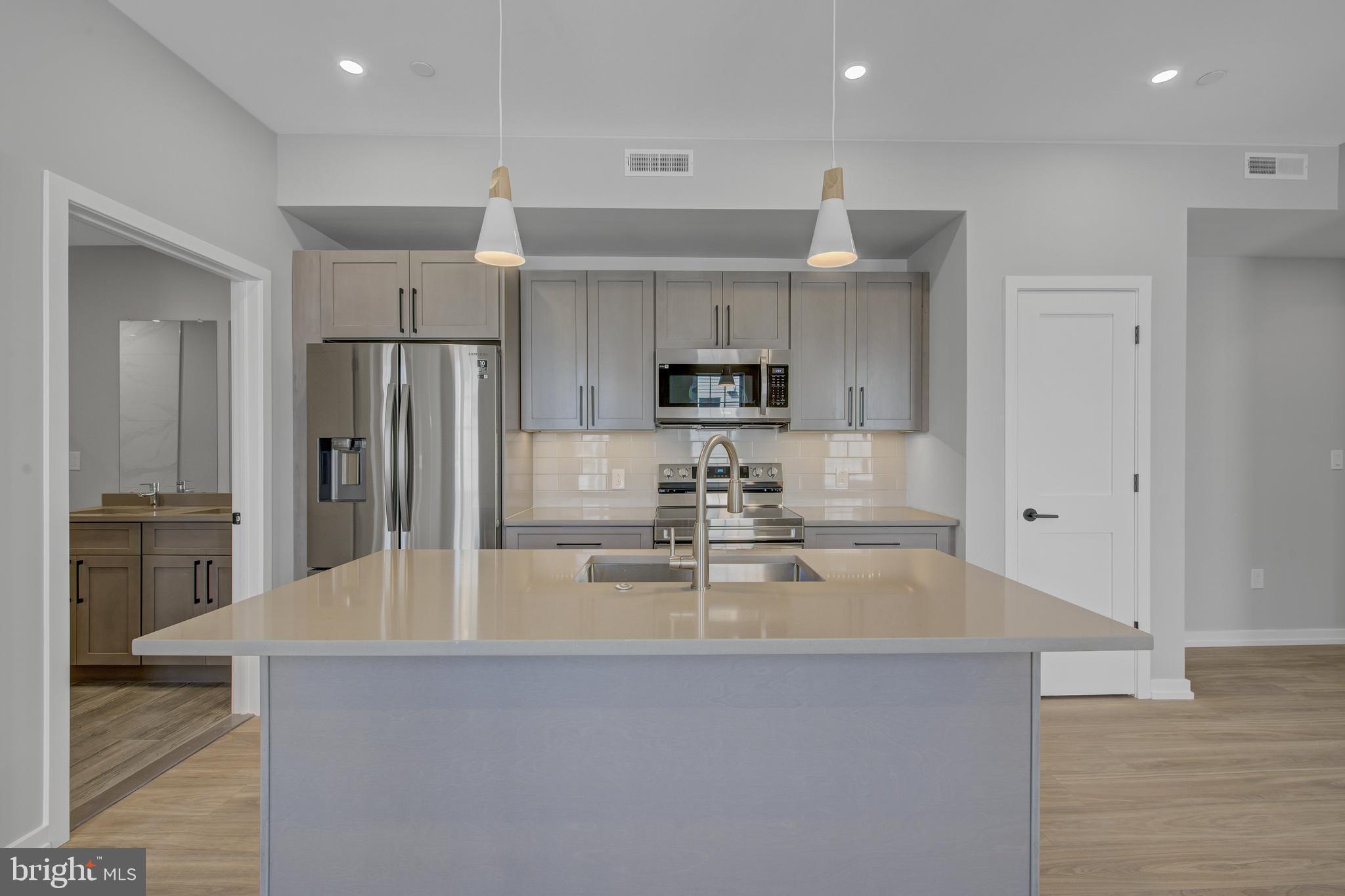 2445 Innovator Way, Unit 3D Philadelphia, PA 19146 - Photo 3 of 19 a view of a kitchen with kitchen island a counter top space stainless steel appliances and cabinets