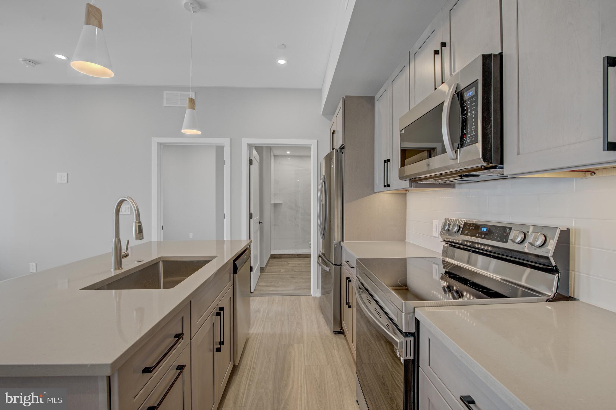 2445 Innovator Way, Unit 3D Philadelphia, PA 19146 - Photo 4 of 19 a kitchen that has a sink and a stove in it