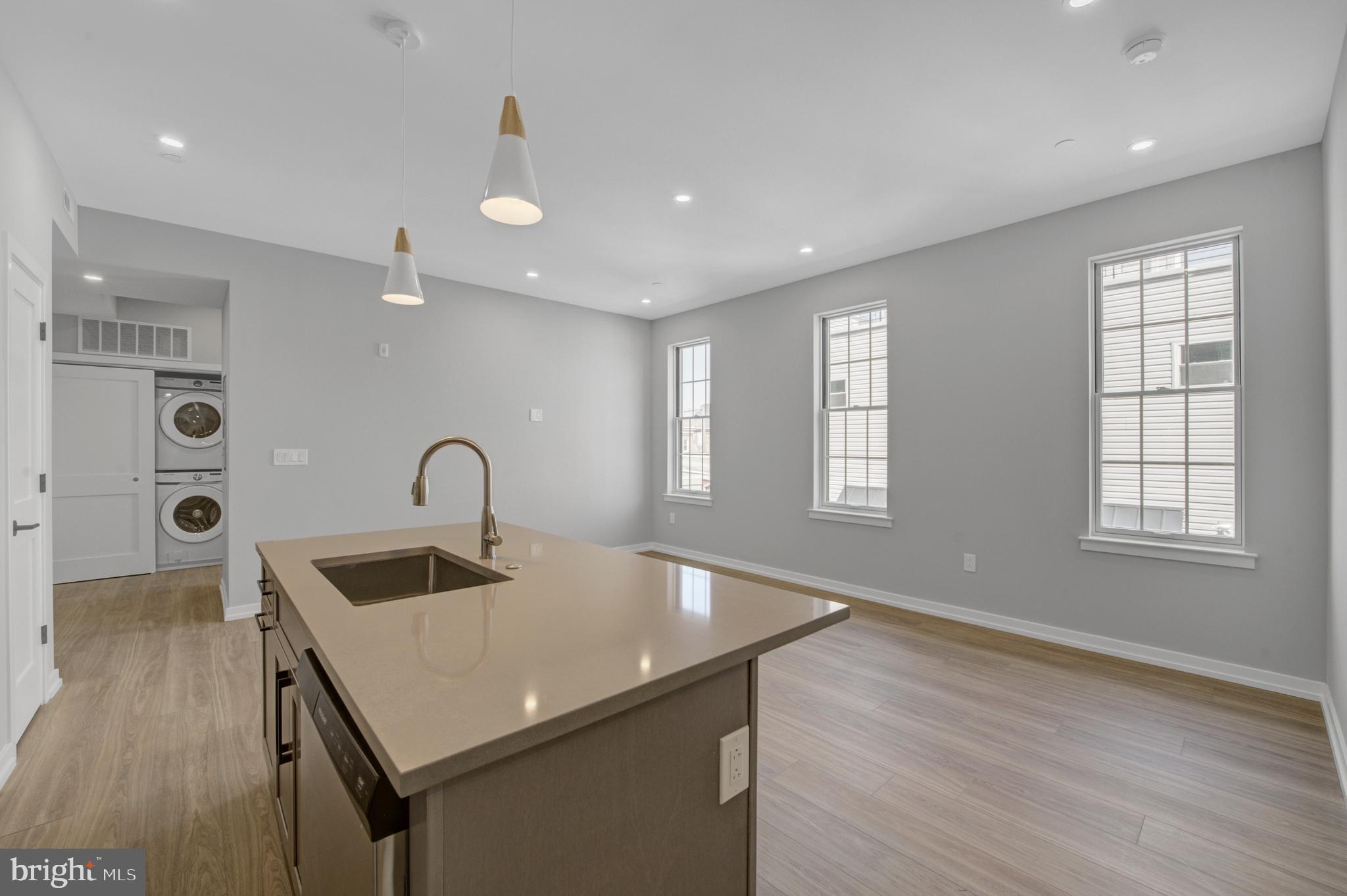 2445 Innovator Way, Unit 3D Philadelphia, PA 19146 - Photo 5 of 19 a kitchen with sink cabinets and wooden floor