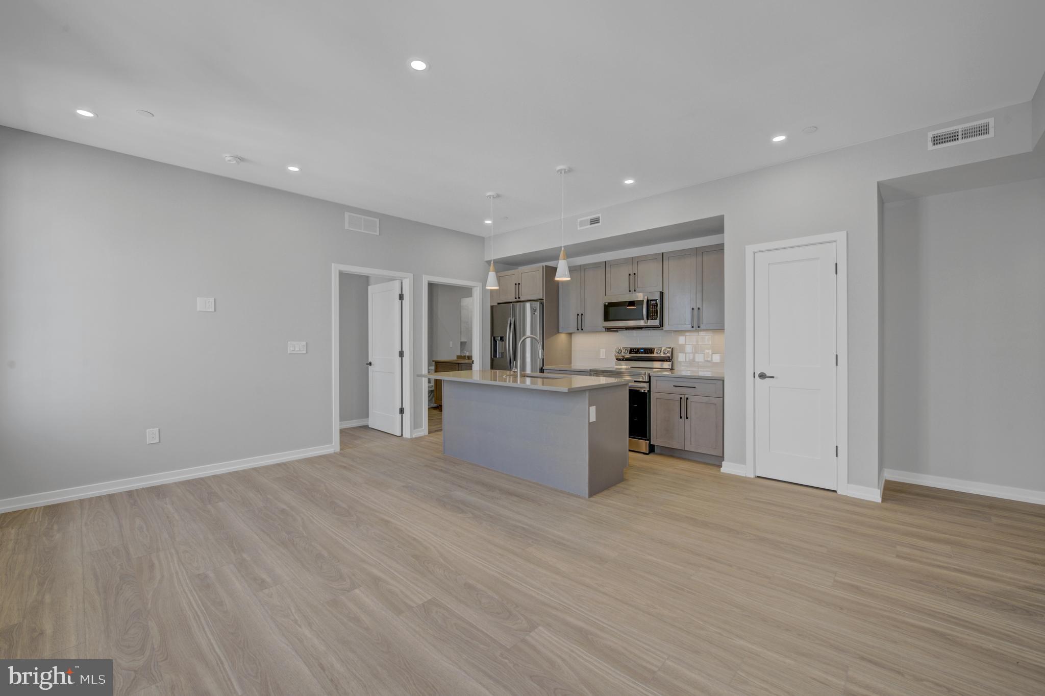 2445 Innovator Way, Unit 3D Philadelphia, PA 19146 - Photo 6 of 19 a view of kitchen with refrigerator sink and center island