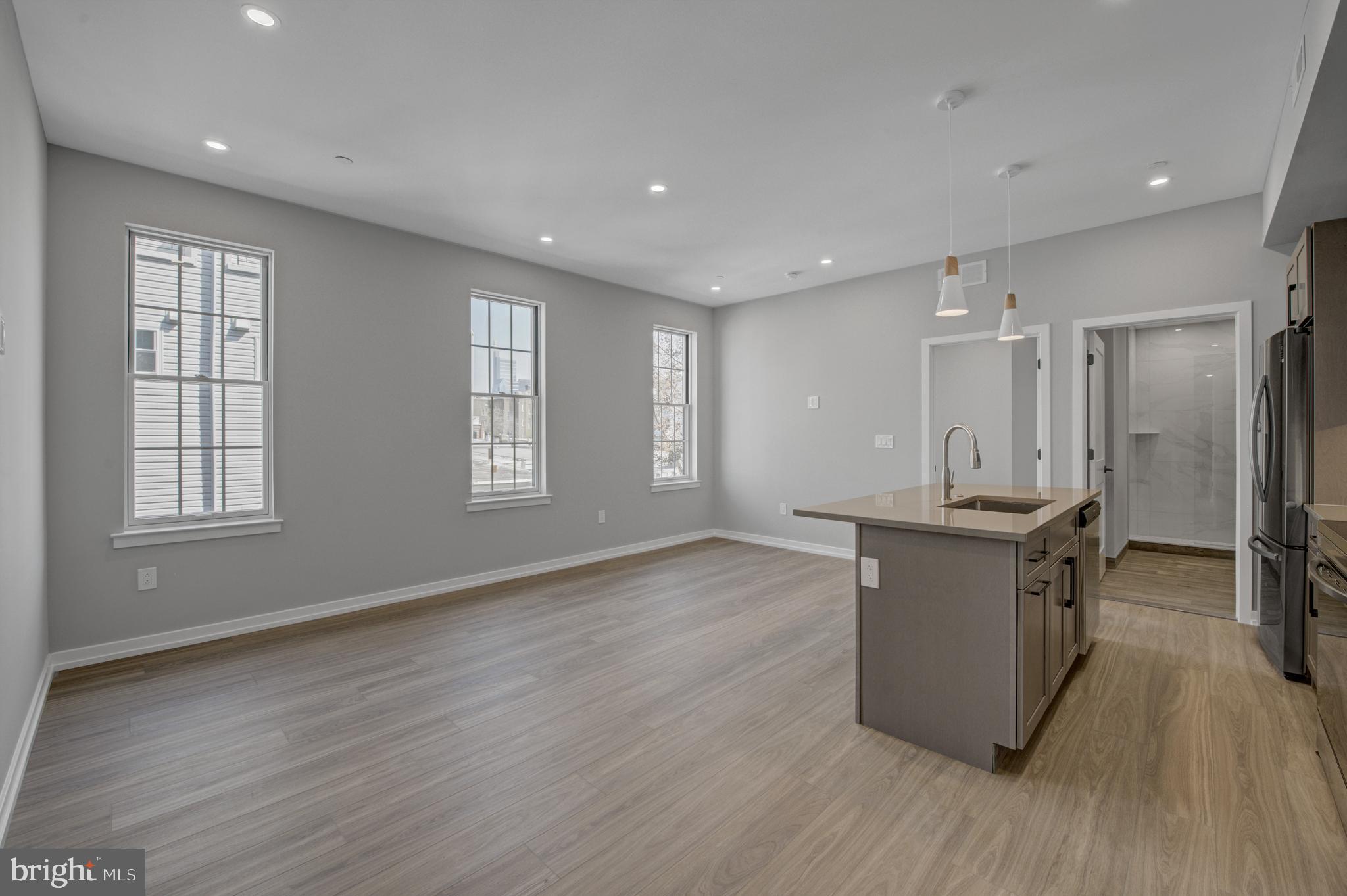 2445 Innovator Way, Unit 3D Philadelphia, PA 19146 - Photo 7 of 19 a view of kitchen with stainless steel appliances granite countertop refrigerator sink and wooden floor
