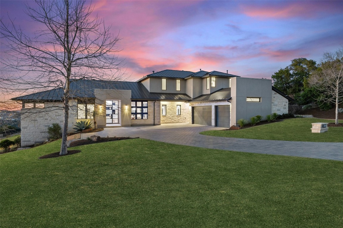 a front view of a house with a garden