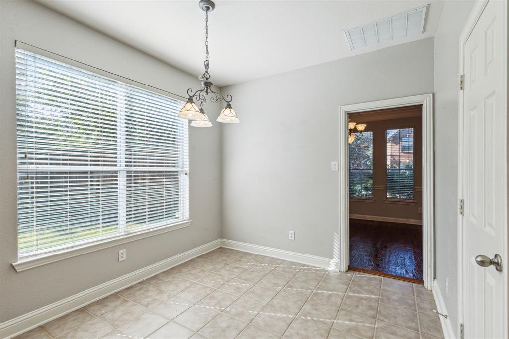 3370 Nation Drive Frisco, TX 75034 - Photo 13 of 37 a view of an empty room with a window and a chandelier