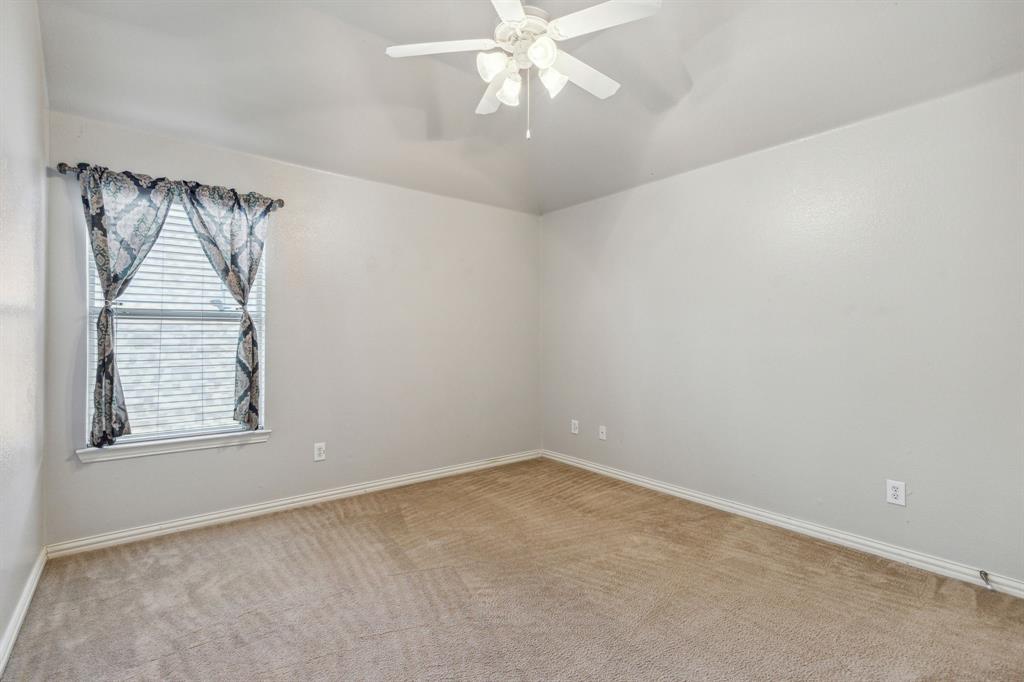 3370 Nation Drive Frisco, TX 75034 - Photo 25 of 37 an empty room with a chandelier fan and windows