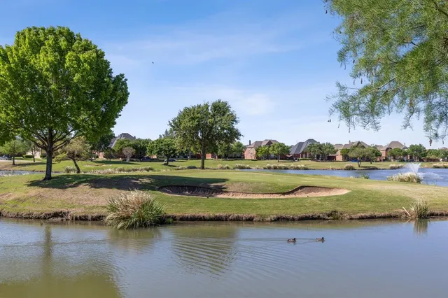 a view of a lake with houses yard and lake view