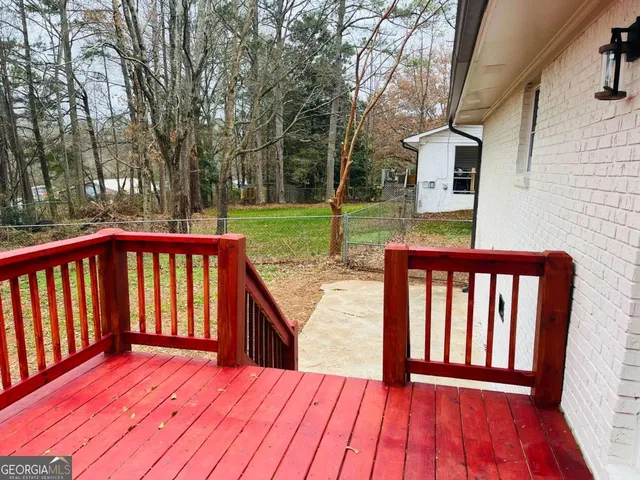 a view of backyard with a deck
