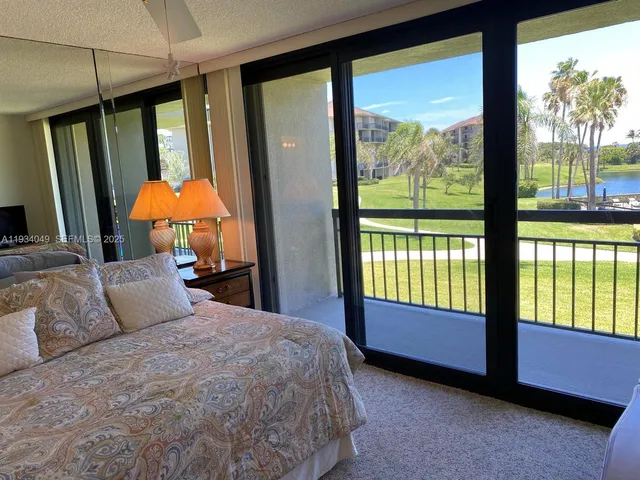 a bedroom with a bed and large window with outer view