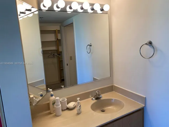 a bathroom with a sink vanity and a mirror