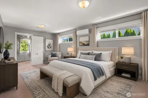 a bedroom with a bed and a large window