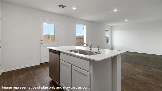 a view of kitchen with microwave and cabinets