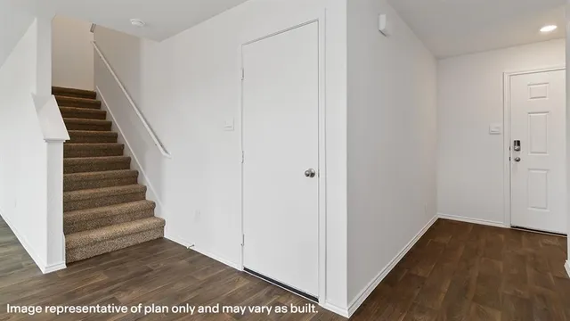 a view of a hallway with wooden floor and entryway