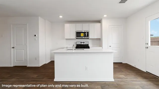 a kitchen with a stove and a microwave