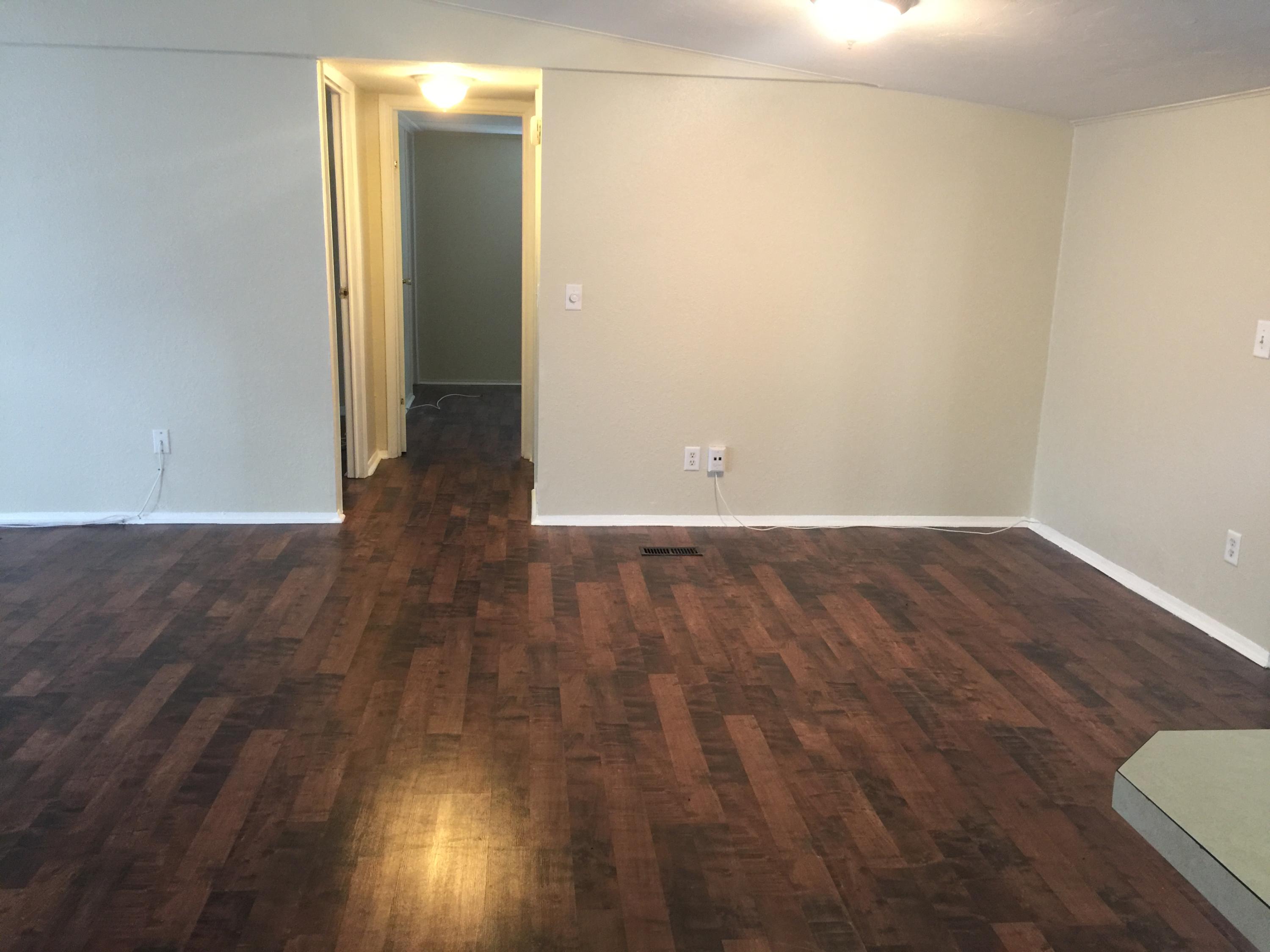 10434 Marina Way Boca Raton, FL 33428 - Photo 5 of 8 an empty room with wooden floor and windows