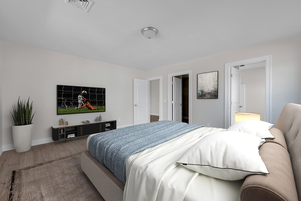 7 L Stevens Road, Unit B Charlton, MA 01507 - Photo 15 of 23 a bedroom with a bed and a flat screen tv