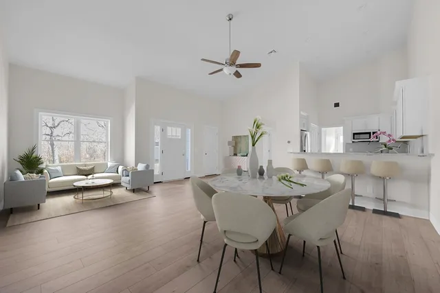 a view of a dining room with furniture and wooden floor