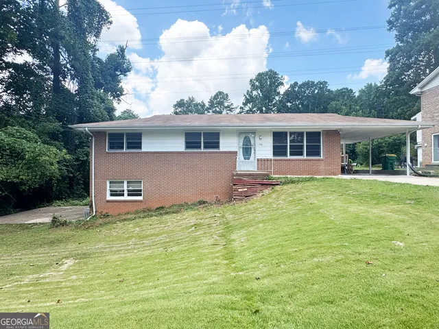 a backyard of a house with yard and outdoor seating