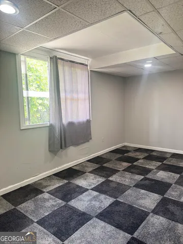 a view of a room with a black and white checkered floor