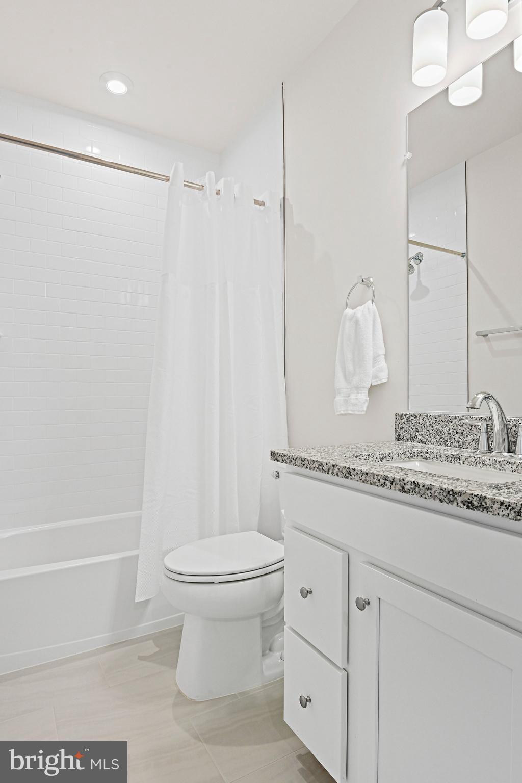 13556 Innovation Station Loop, Unit 15A Herndon, VA 20171 - Photo 13 of 28 a bathroom with a granite countertop sink toilet and shower