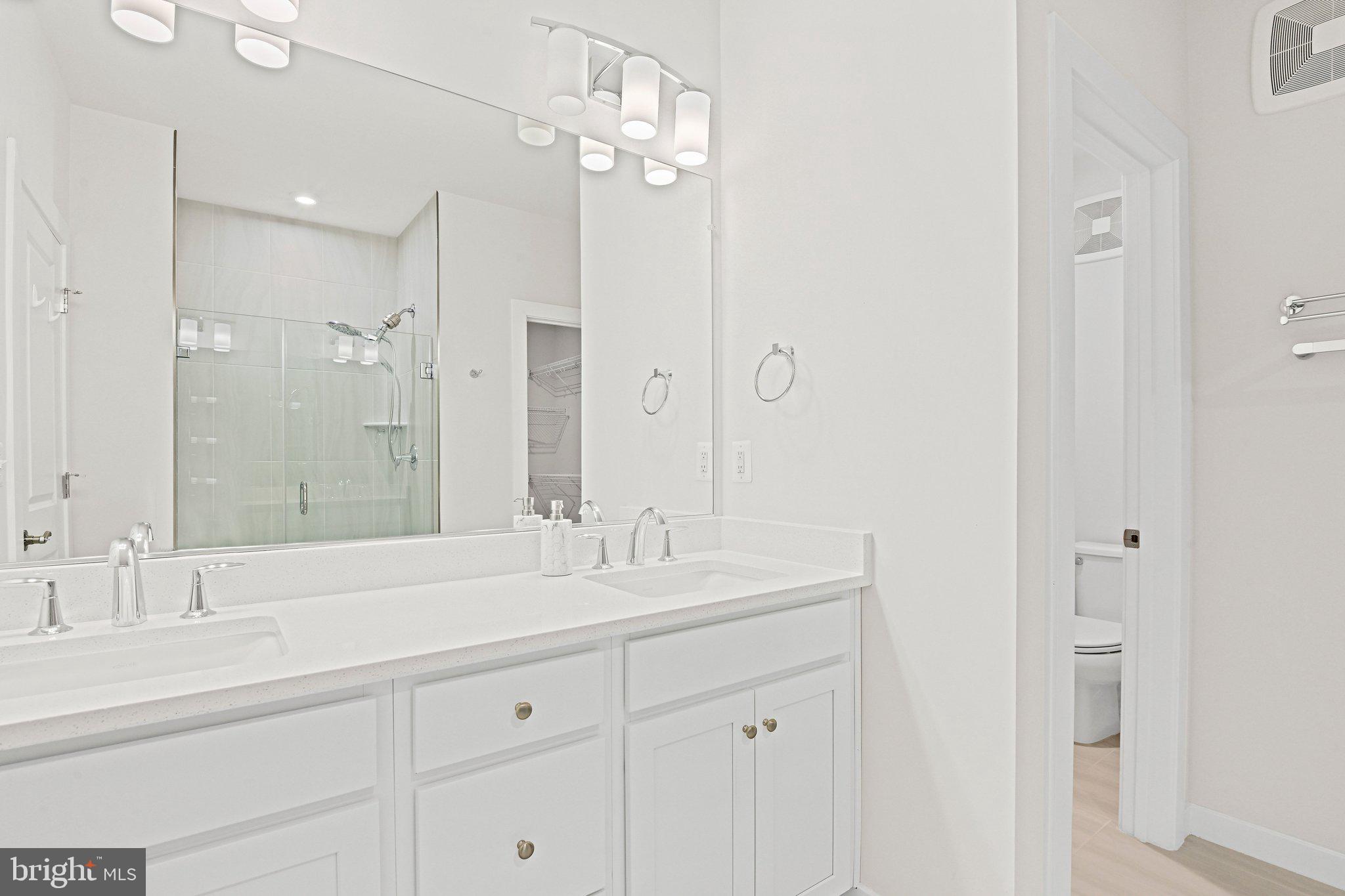 13556 Innovation Station Loop, Unit 15A Herndon, VA 20171 - Photo 15 of 28 a bathroom with double vanity sinks and a mirror