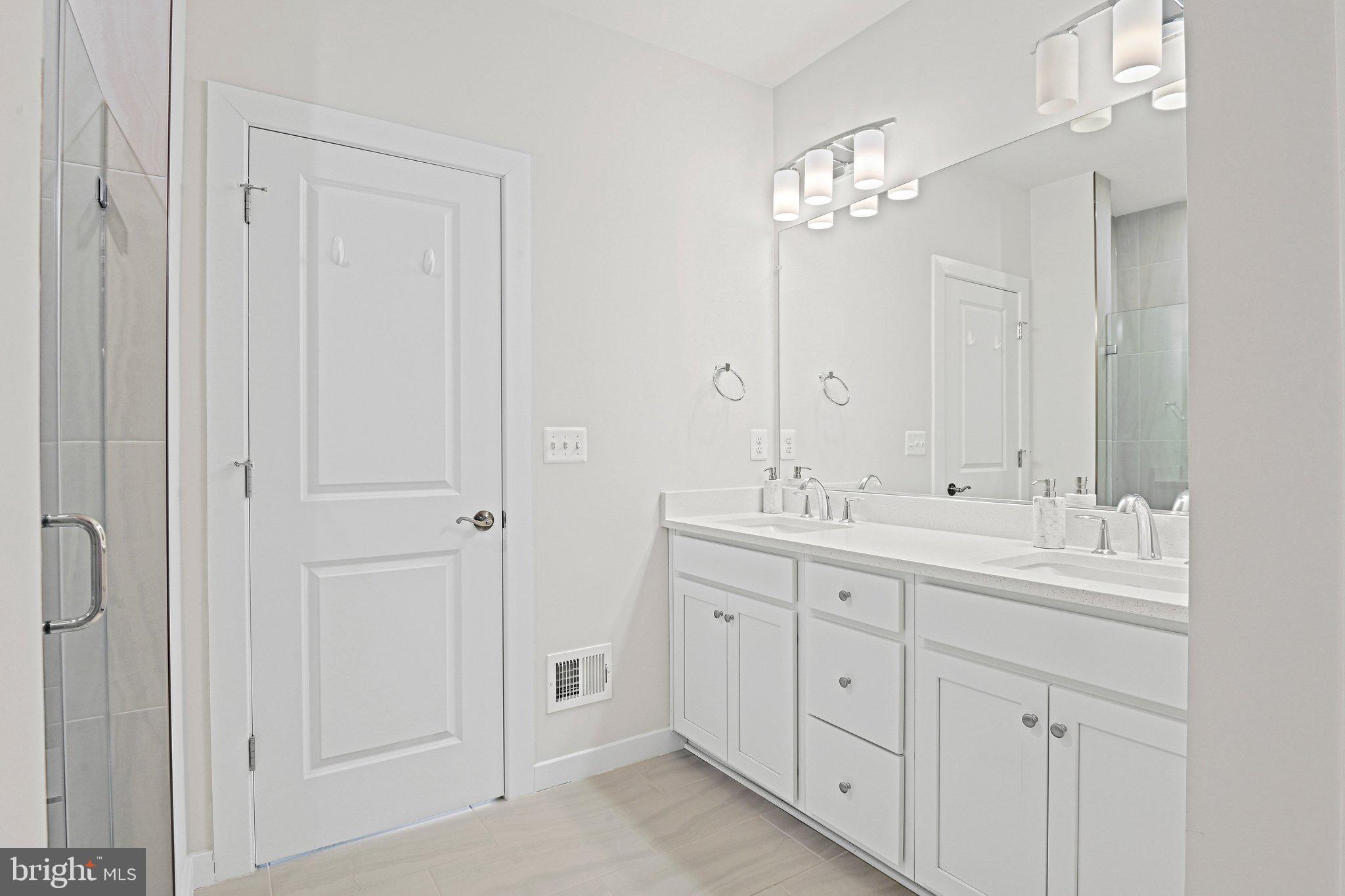 13556 Innovation Station Loop, Unit 15A Herndon, VA 20171 - Photo 17 of 28 a spacious bathroom with double vanity a and a mirror
