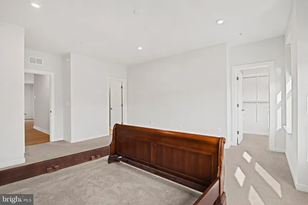 a room with a bed and a dresser