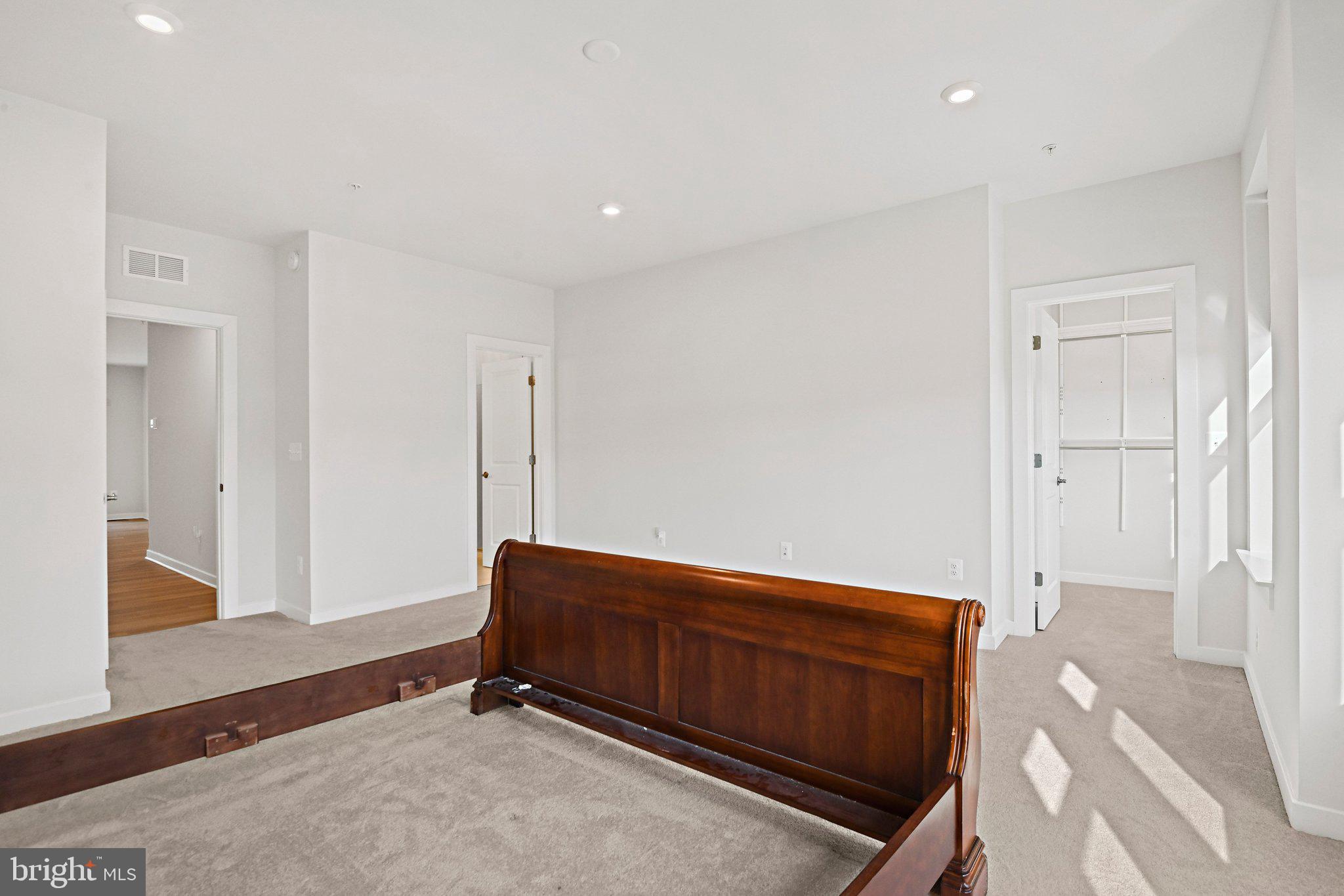 13556 Innovation Station Loop, Unit 15A Herndon, VA 20171 - Photo 19 of 28 a room with a bed and a dresser