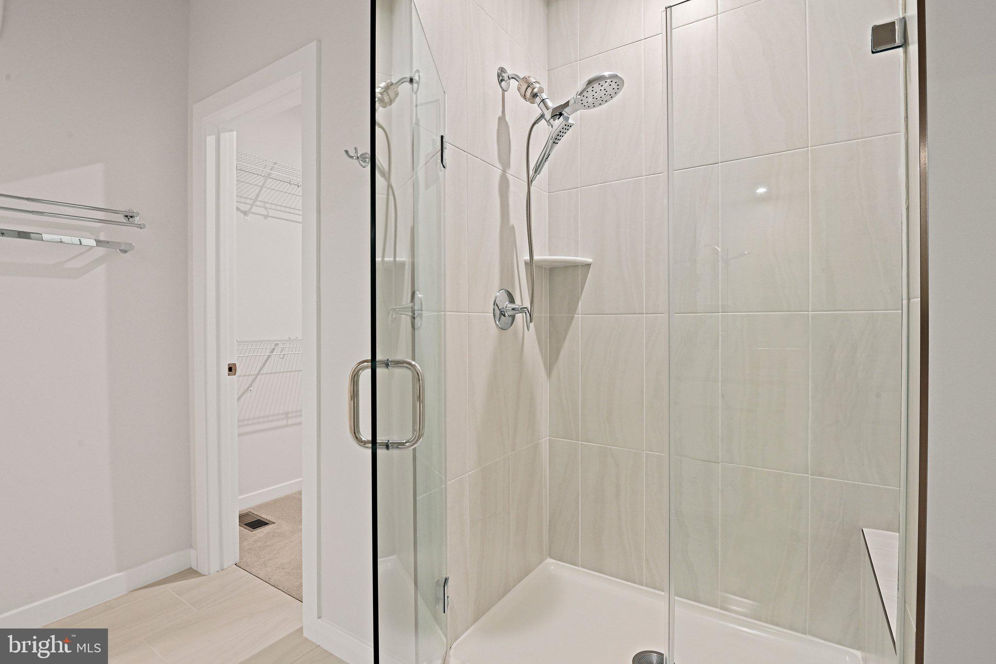 13556 Innovation Station Loop, Unit 15A Herndon, VA 20171 - Photo 20 of 28 a bathroom with a glass shower door