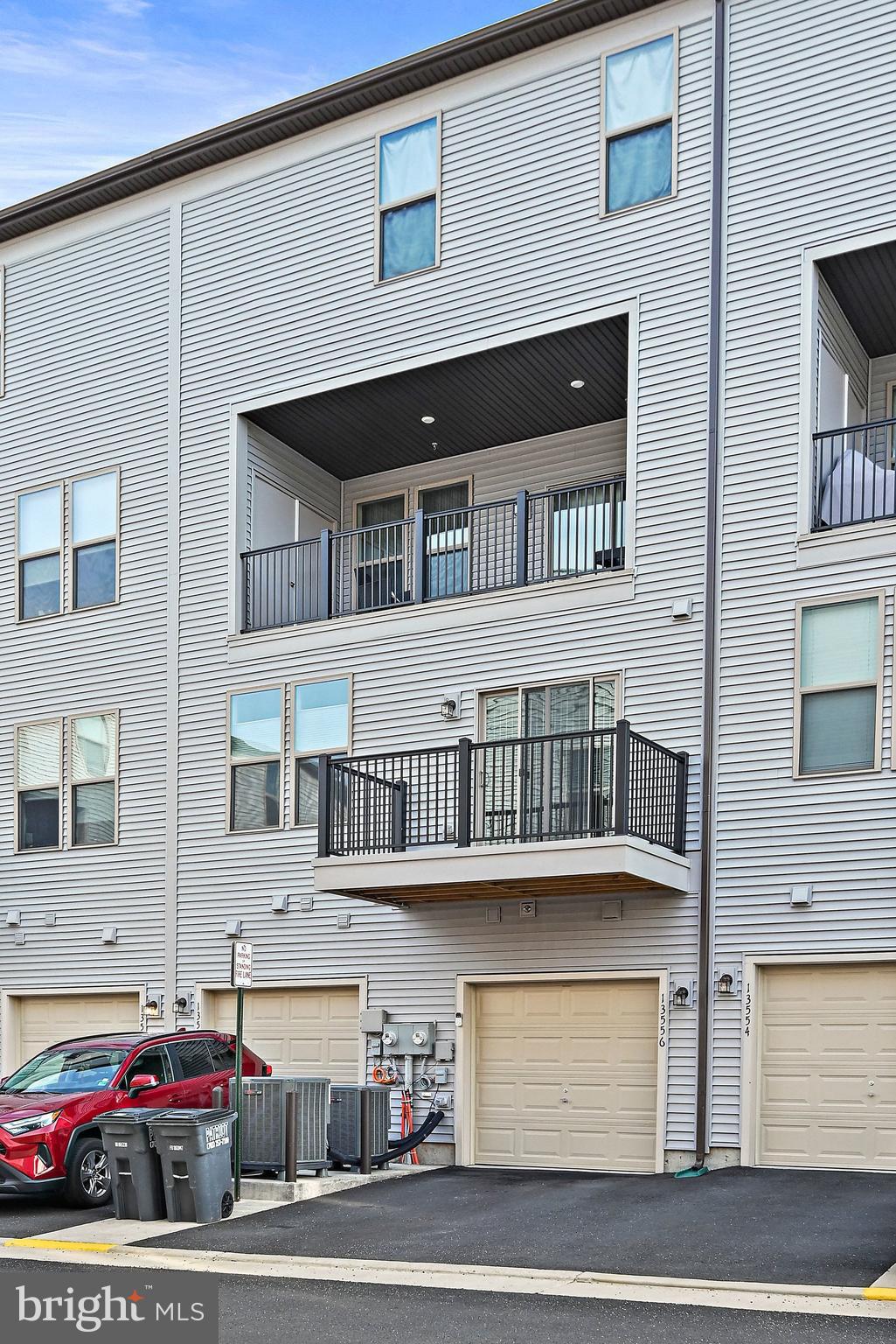 13556 Innovation Station Loop, Unit 15A Herndon, VA 20171 - Photo 24 of 28 a car parked in front of a house