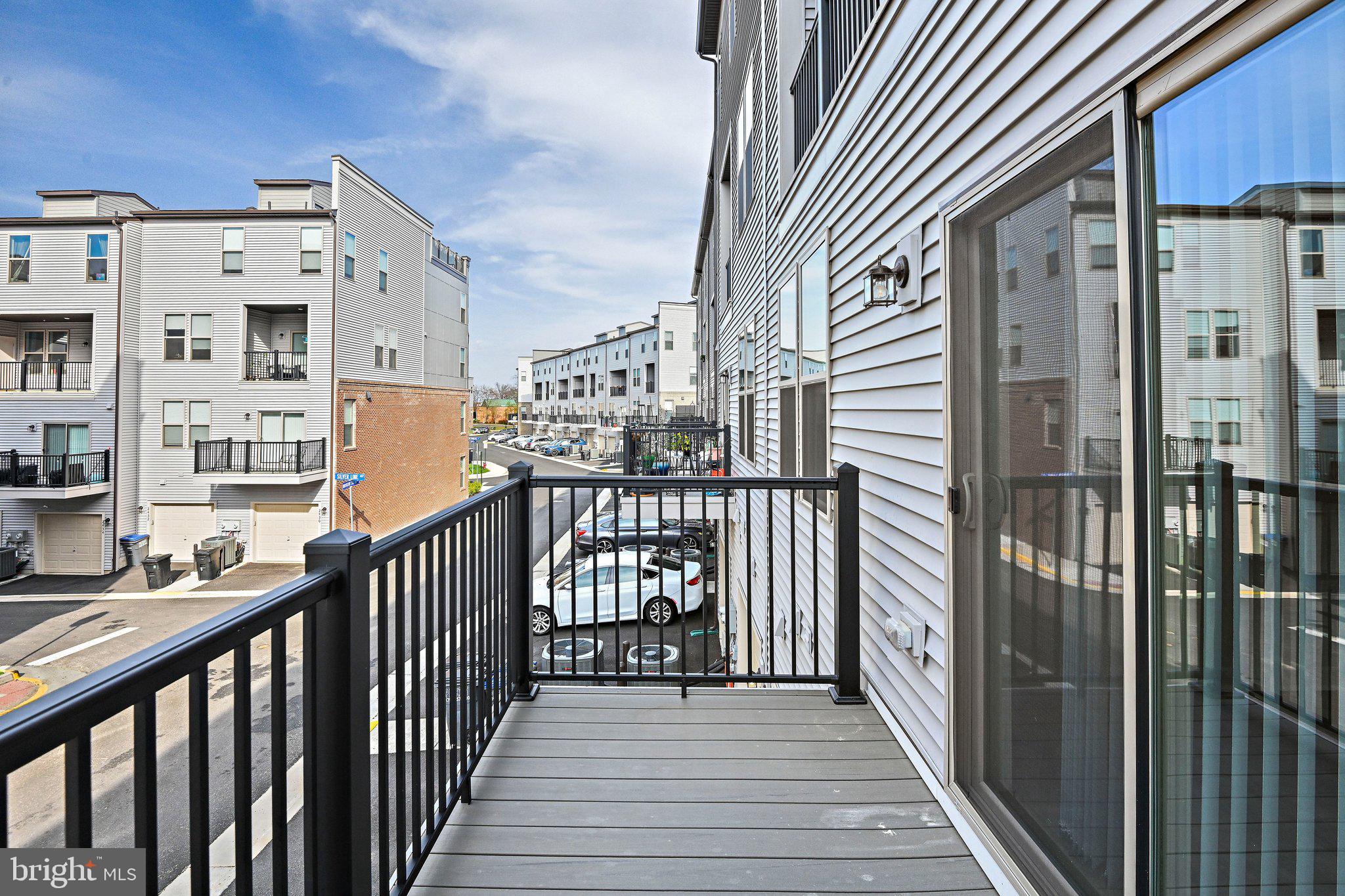 13556 Innovation Station Loop, Unit 15A Herndon, VA 20171 - Photo 25 of 28 a view of a balcony with wooden floor