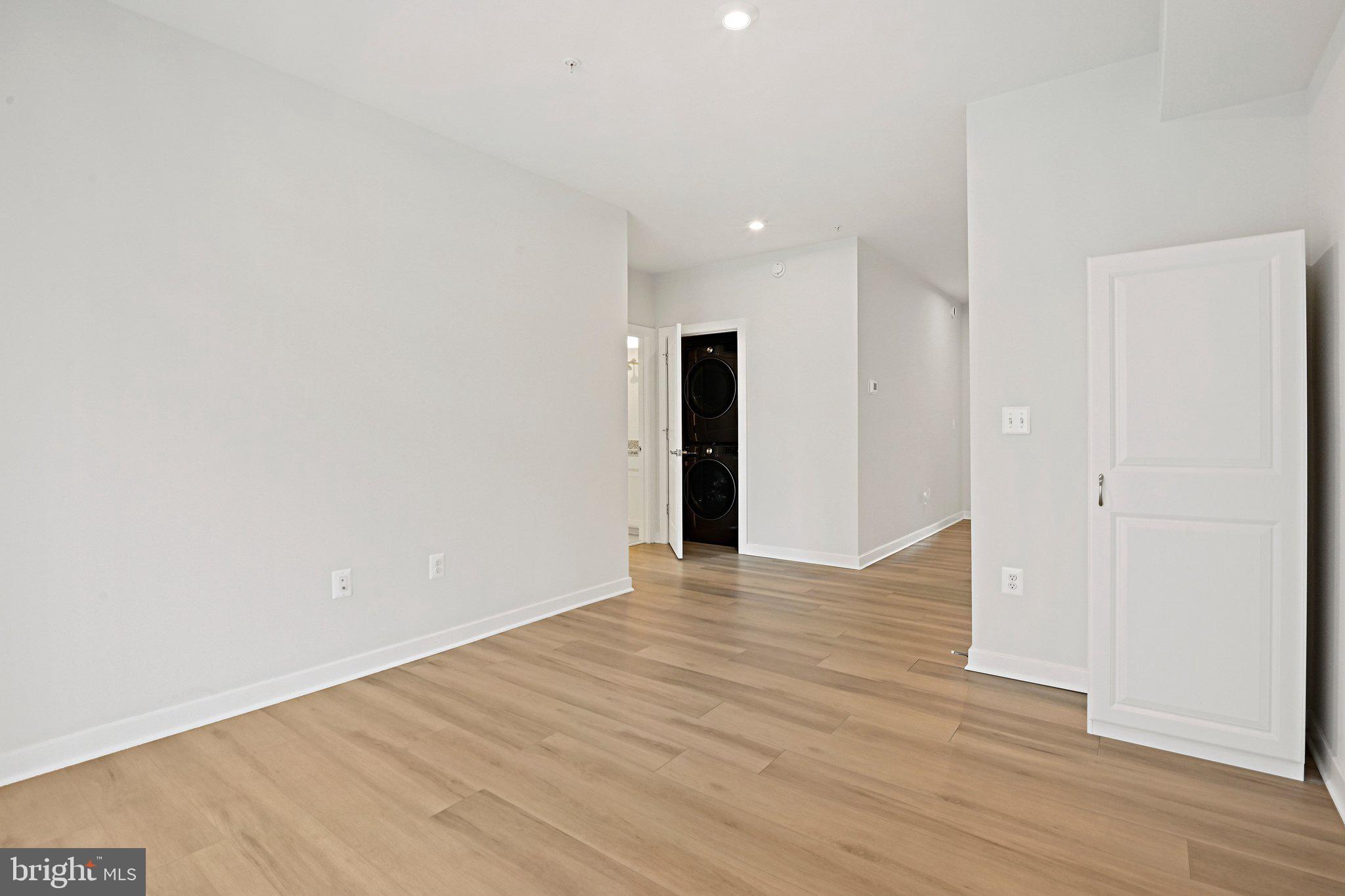 13556 Innovation Station Loop, Unit 15A Herndon, VA 20171 - Photo 6 of 28 a view of an empty room with wooden floor