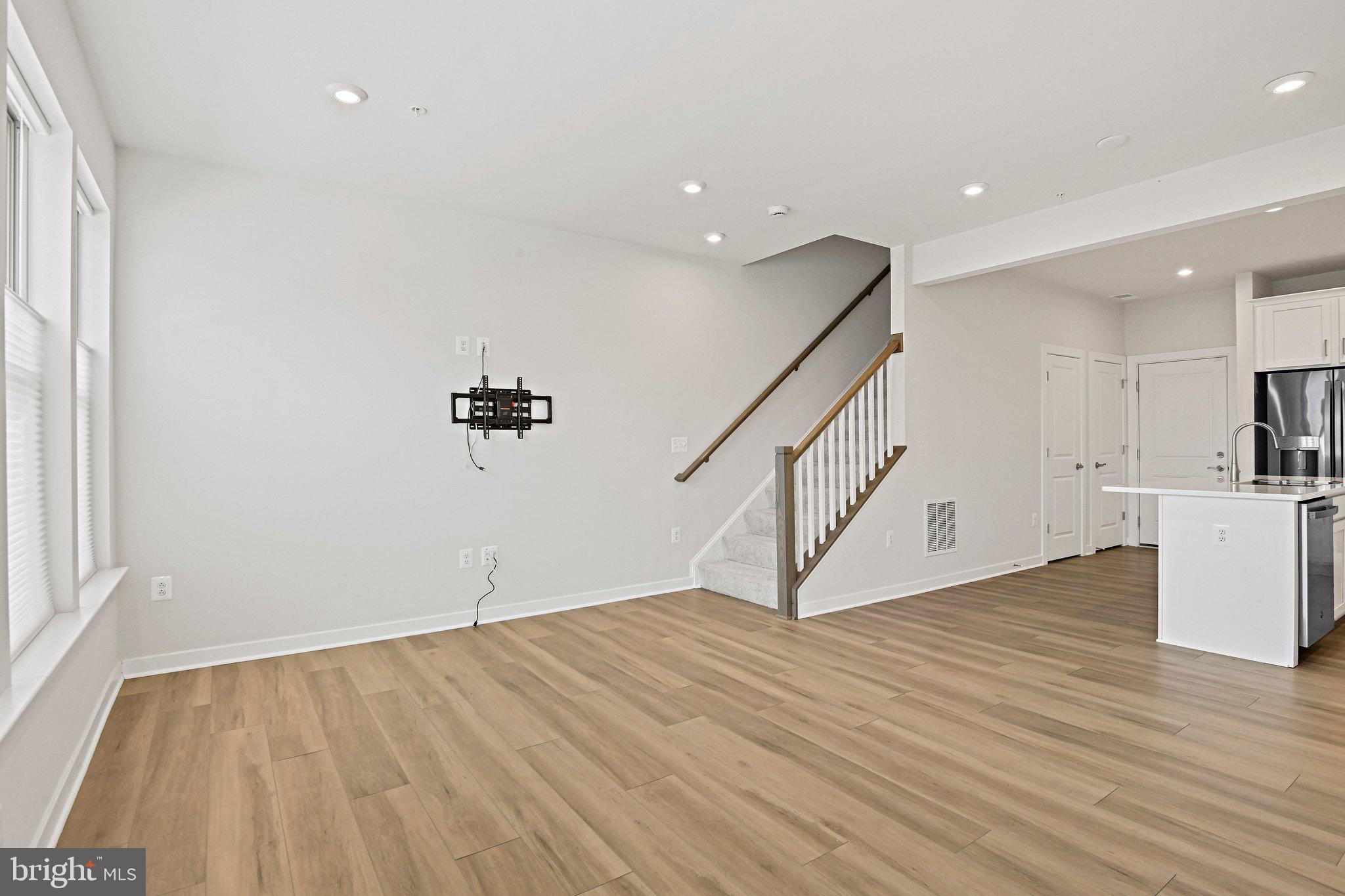 13556 Innovation Station Loop, Unit 15A Herndon, VA 20171 - Photo 7 of 28 a view of a room with wooden floor and stairs