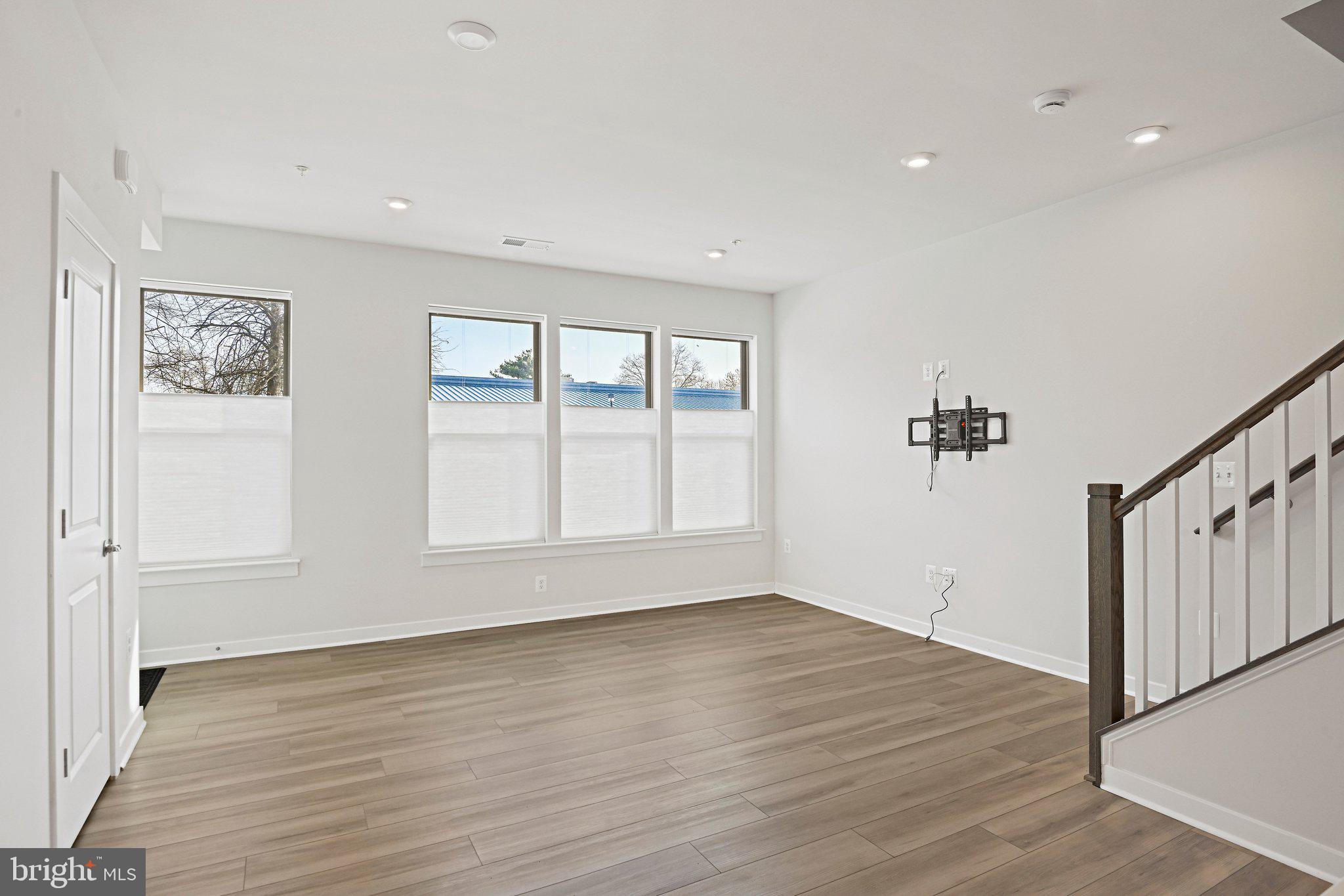 13556 Innovation Station Loop, Unit 15A Herndon, VA 20171 - Photo 8 of 28 wooden floor in an empty room with a window