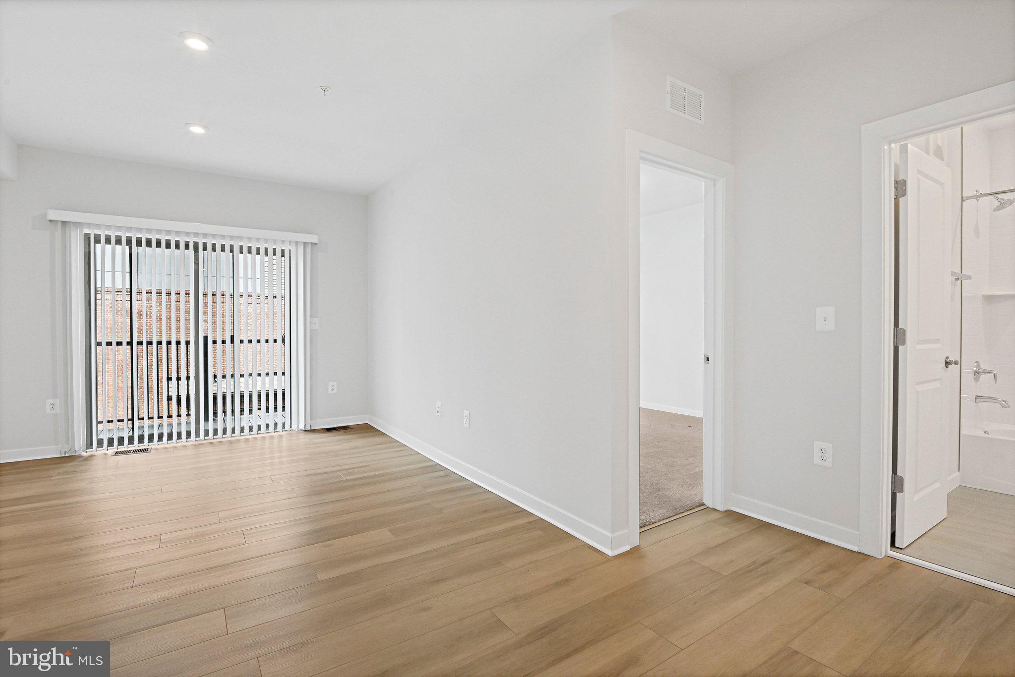 13556 Innovation Station Loop, Unit 15A Herndon, VA 20171 - Photo 9 of 28 a view of an empty room with wooden floor
