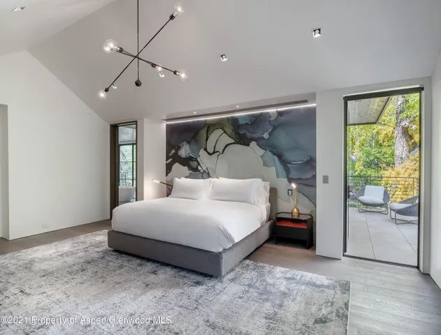 a bedroom with a bed lamp closet and window