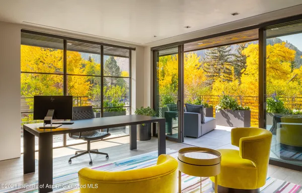 a living room with furniture and a floor to ceiling window