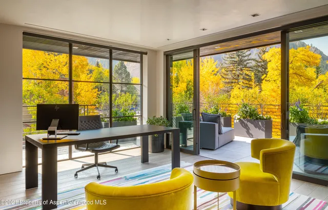 a living room with furniture and a floor to ceiling window
