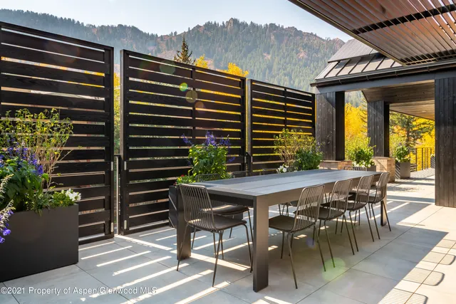 a view of a patio with table and chairs and potted plants