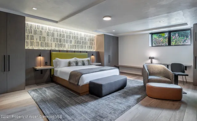 a bedroom with bed couch and window