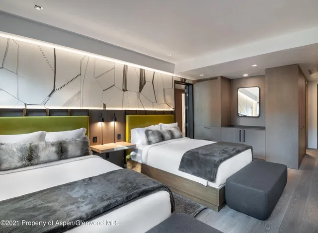 a bedroom with two beds and a couch