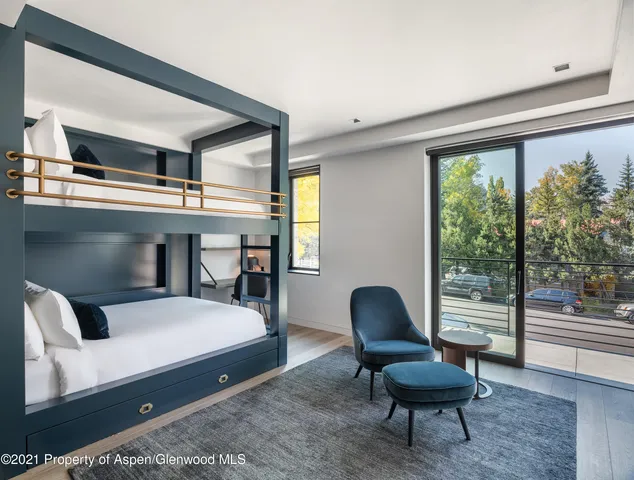 a bedroom with furniture and a large window