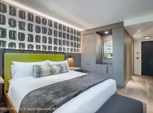 a bedroom with a bed and a lamp