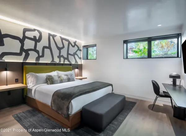 a bedroom with a bed and a chair
