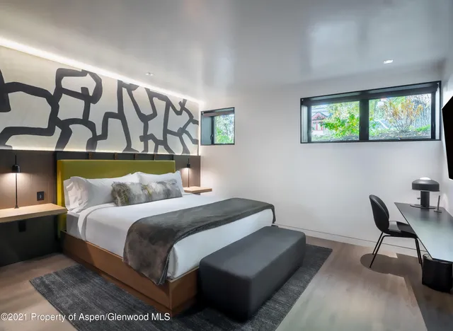 a bedroom with a bed and a chair