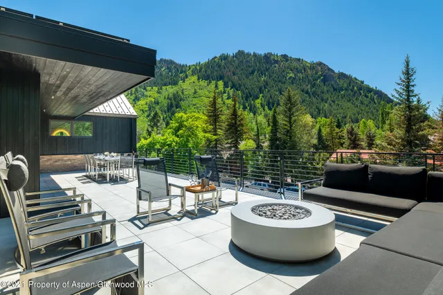a view of a patio with couches table and chairs and potted plants
