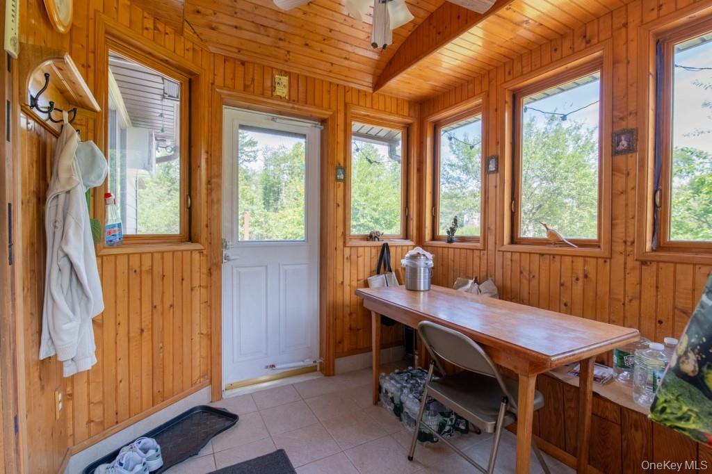 139 Haddock Road Monticello, NY 12701 - Photo 22 of 40 Sunroom / solarium with wood walls, wooden ceiling, and tile patterned floors